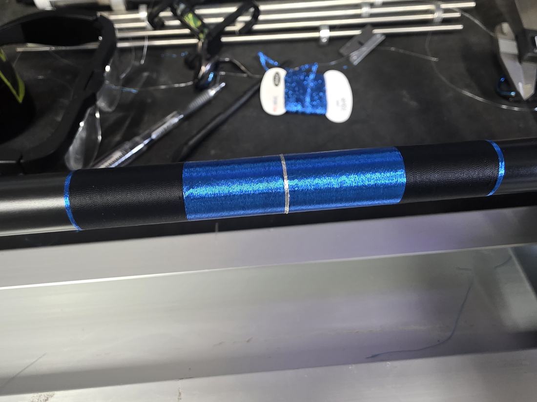 Blue metallic wrap on a rod in the workshop