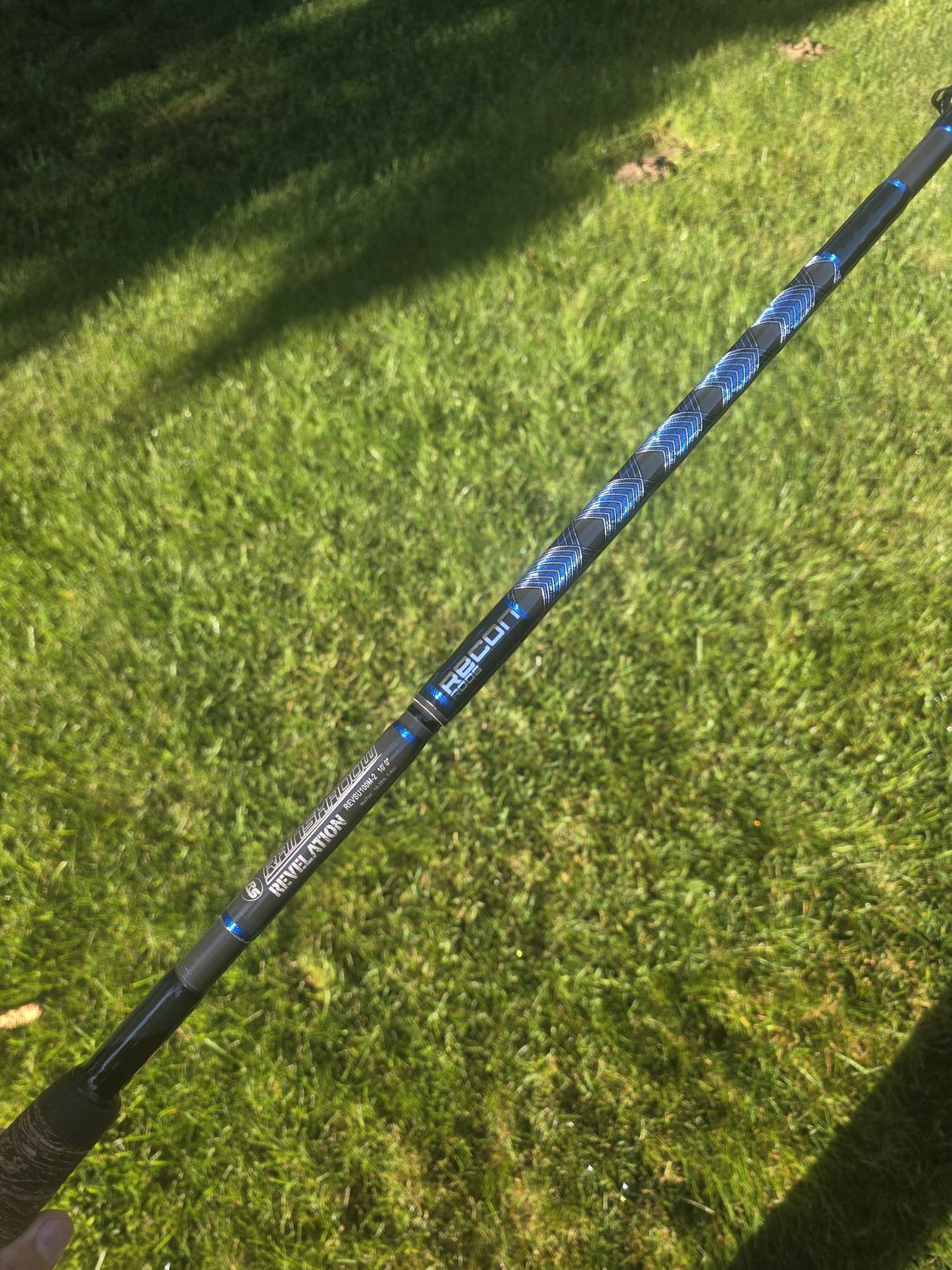Blue wrapped rod section photographed on grass