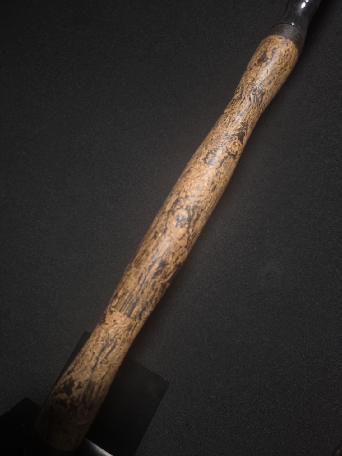 Natural cork rod handle against a dark backdrop