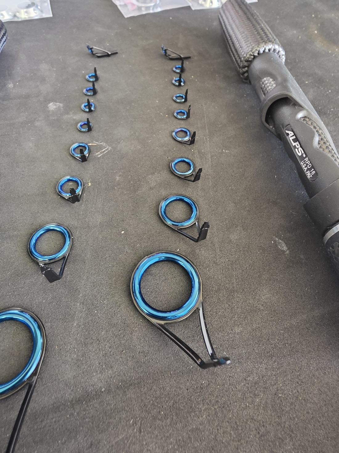 Blue guide frames and rod components laid out before assembly