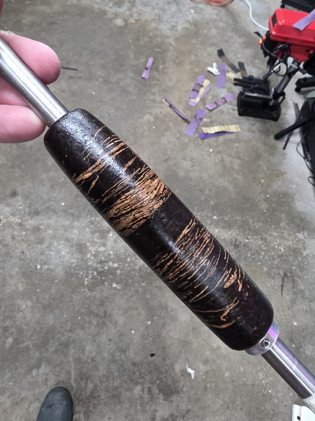 Patterned rod grip being finished on a rod lathe