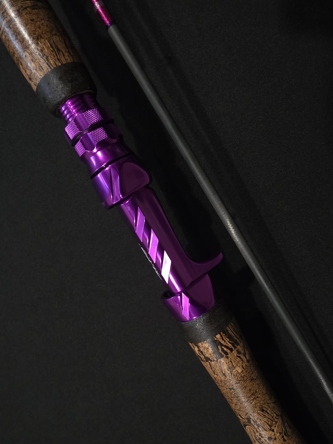 Purple metal reel seat and natural grip on a custom rod