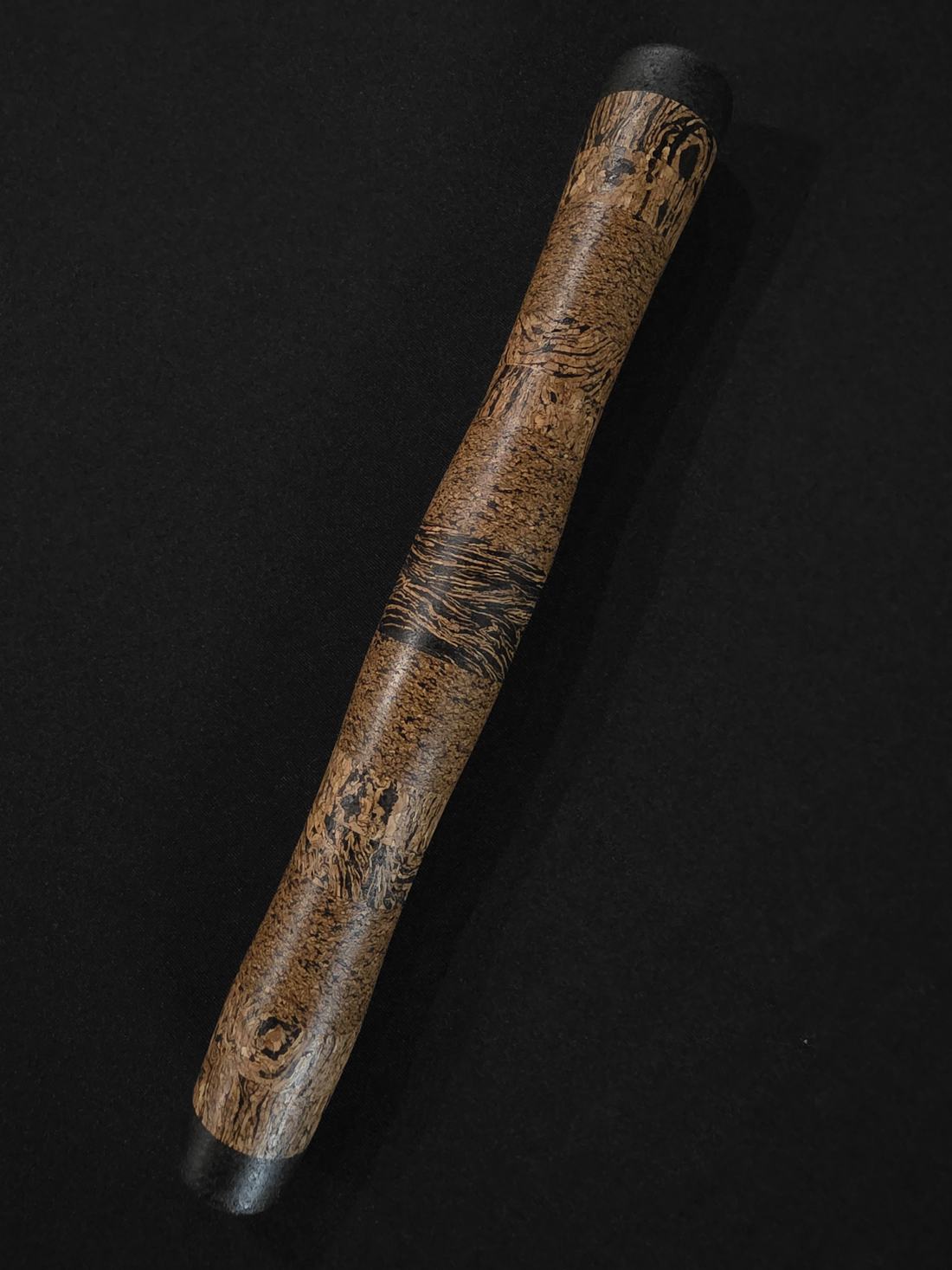 Textured natural rod grip against a dark background